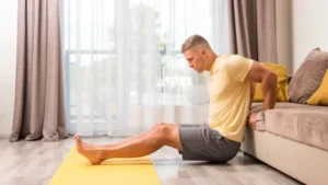 A person performing a gentle lower back stretch at home to relieve spinal tension and improve flexibility.