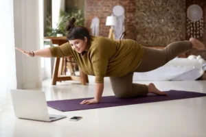 A beginner practicing the best HIIT workout at home for belly fat loss to improve fitness and burn calories.