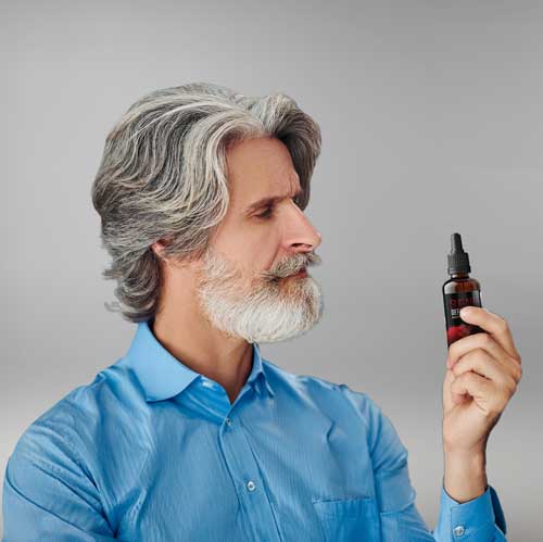 Man examining Sugar Defender bottle - official approved image